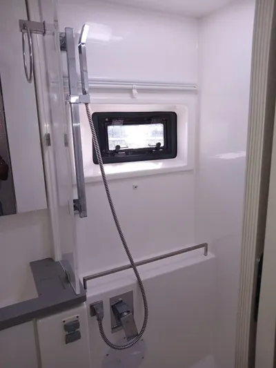 Marylee Yacht Photos Pics Modern bathroom in a 2020 Leopard 45 yacht with a sleek shower and window.