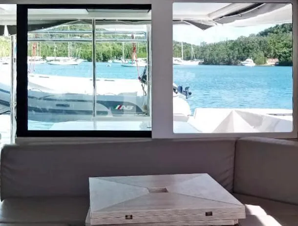 Marylee Yacht Photos Pics Interior view of Leopard 45 yacht with scenic water and boats outside.