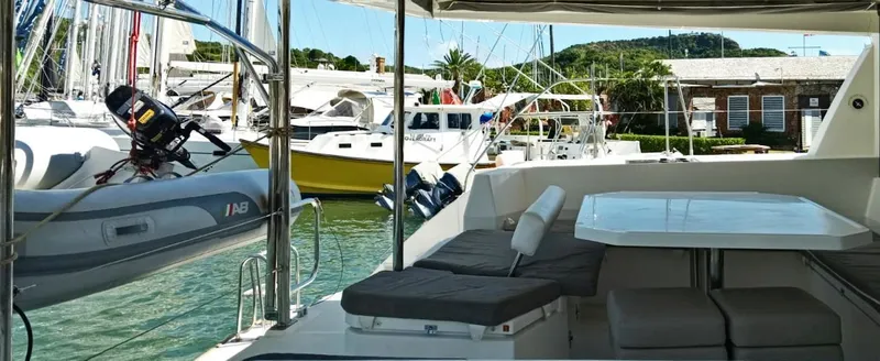Marylee Yacht Photos Pics Leopard 45 catamaran's outdoor seating area in a marina, 2020 model.