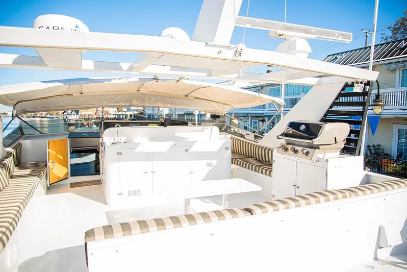 Happy Ours Yacht Photos Pics Luxurious 1989 Broward 85 Raised Pilothouse yacht with spacious deck and seating area.