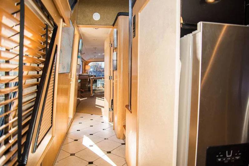 Happy Ours Yacht Photos Pics Interior hallway of 1989 Broward 85 Raised Pilothouse yacht with modern design elements.
