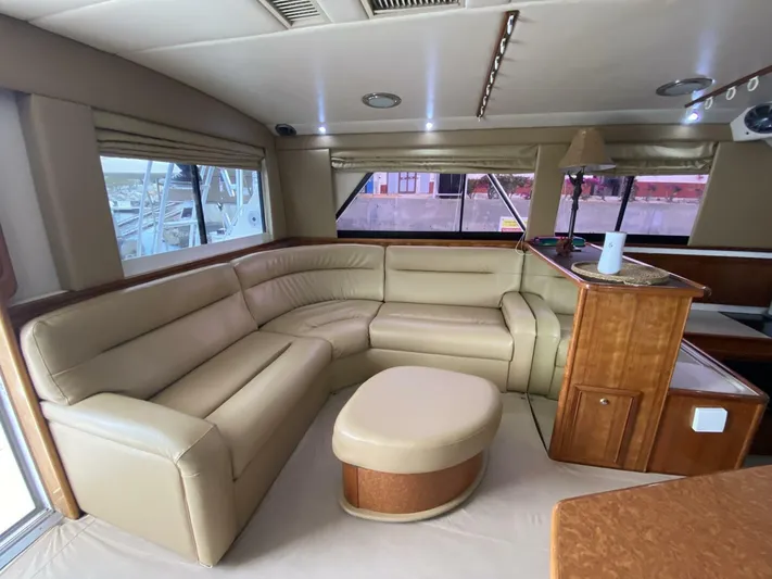 Warrior Yacht Photos Pics Luxurious interior of 2001 Riviera 43 Flybridge yacht with beige leather seating.