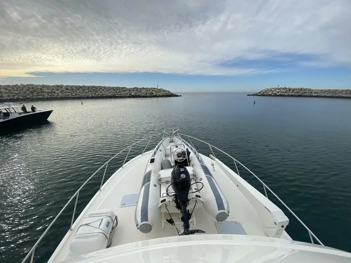 Warrior Yacht Photos Pics Bow view of 2001 Riviera 43 Flybridge yacht entering calm harbor waters.