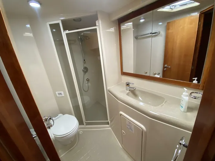 Warrior Yacht Photos Pics Bathroom interior of 2001 Riviera 43 Flybridge yacht with shower, sink, and toilet.