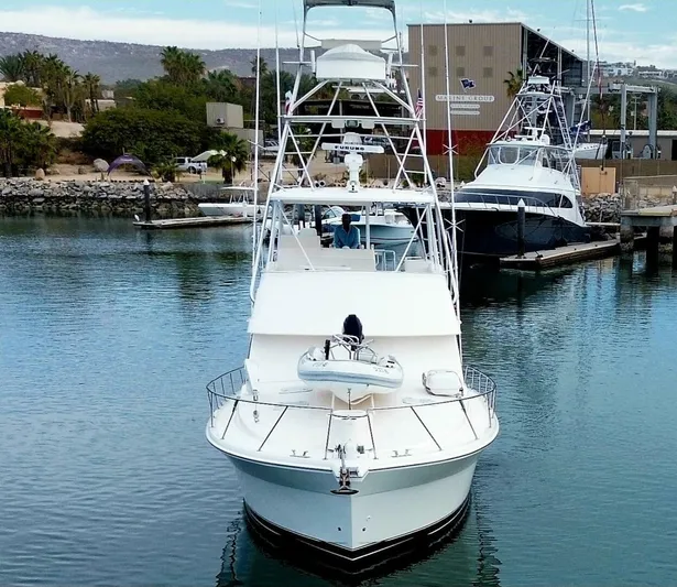 Warrior Yacht Photos Pics Front view of a 2001 Riviera 43 Flybridge yacht docked in a marina.