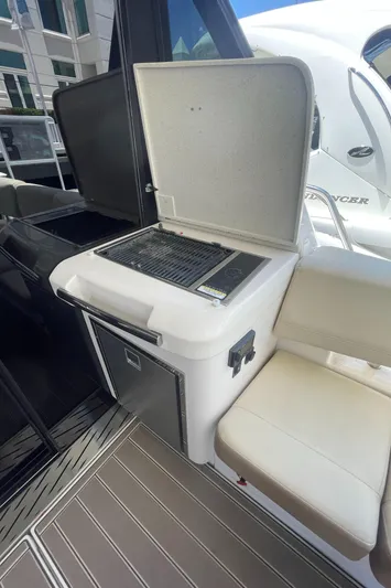 Caribbean Smile Yacht Photos Pics Outdoor grill and seating area on a 2019 Regal 42 Grande Coupe yacht.