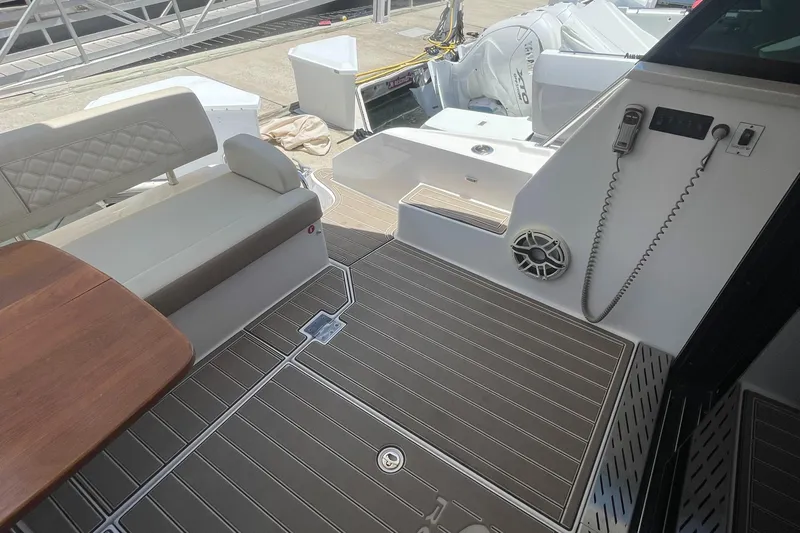 Caribbean Smile Yacht Photos Pics 2019 Regal 42 Grande Coupe yacht deck with seating and table.