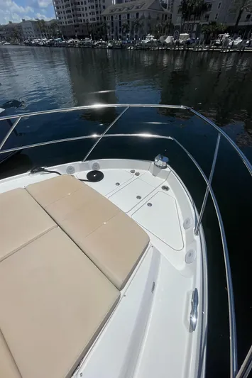 Caribbean Smile Yacht Photos Pics 2019 Regal 42 Grande Coupe yacht bow with sun pads docked in marina.