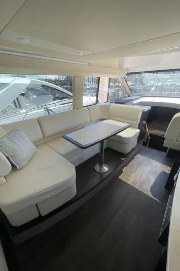Caribbean Smile Yacht Photos Pics 2019 Regal 42 Grande Coupe yacht interior with plush seating and dining table.