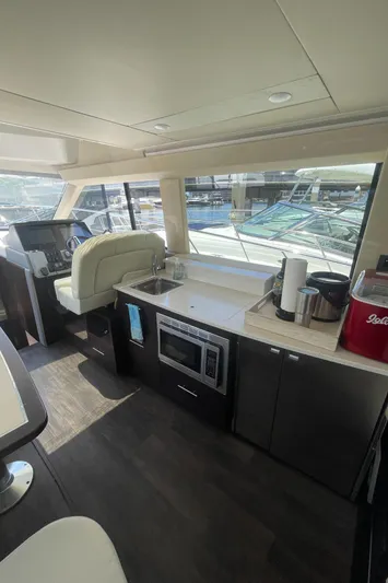 Caribbean Smile Yacht Photos Pics Interior of 2019 Regal 42 Grande Coupe yacht with modern kitchen and helm station.