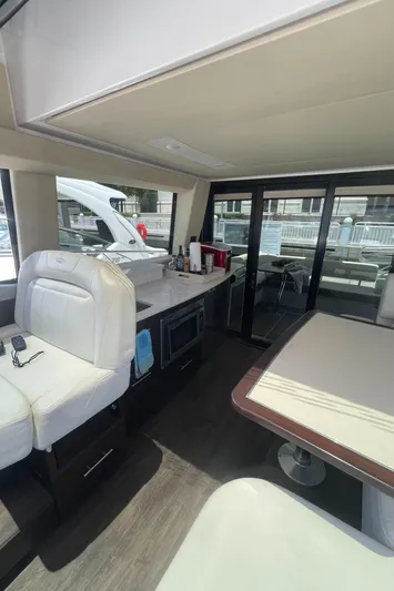 Caribbean Smile Yacht Photos Pics Interior of 2019 Regal 42 Grande Coupe yacht with modern seating and kitchen area.