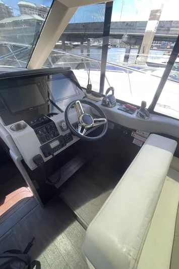 Caribbean Smile Yacht Photos Pics 2019 Regal 42 Grande Coupe yacht helm with modern controls and waterfront view.