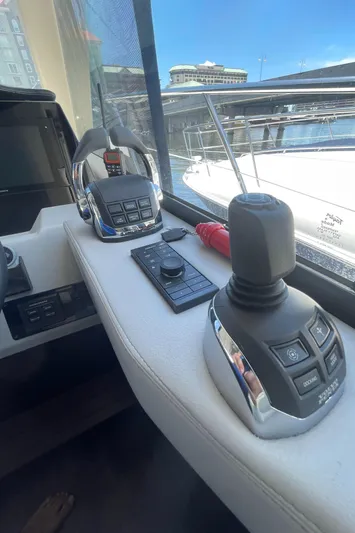 Caribbean Smile Yacht Photos Pics Control panel of a 2019 Regal 42 Grande Coupe yacht at a marina.