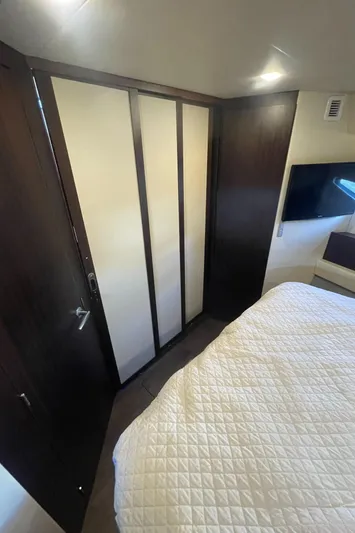 Caribbean Smile Yacht Photos Pics Interior cabin of 2019 Regal 42 Grande Coupe with bed and TV.