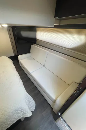 Caribbean Smile Yacht Photos Pics Interior of 2019 Regal 42 Grande Coupe with white sofa and bed.