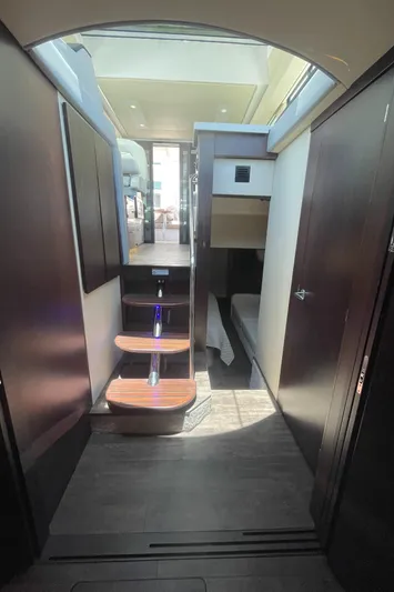 Caribbean Smile Yacht Photos Pics Interior of 2019 Regal 42 Grande Coupe yacht with modern design and wooden steps.