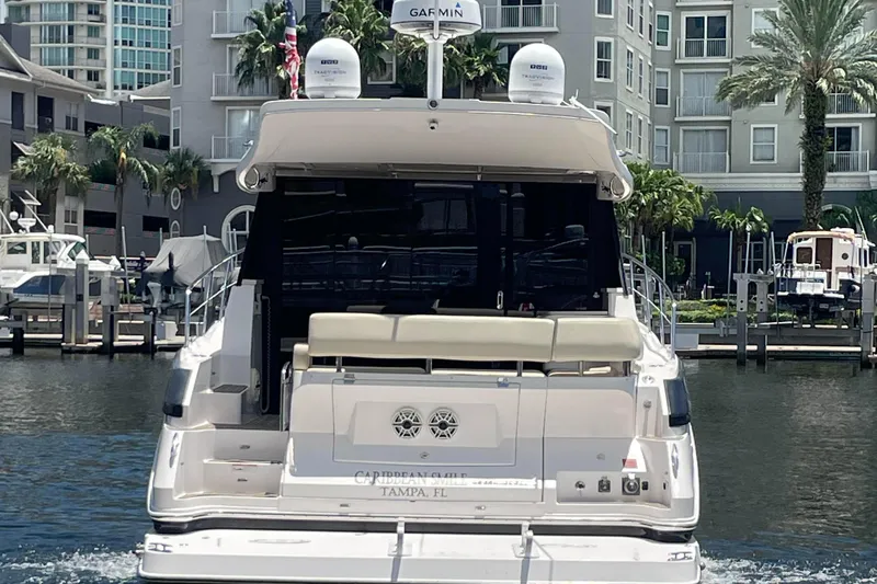 Caribbean Smile Yacht Photos Pics 2019 Regal 42 Grande Coupe yacht docked in marina, rear view.