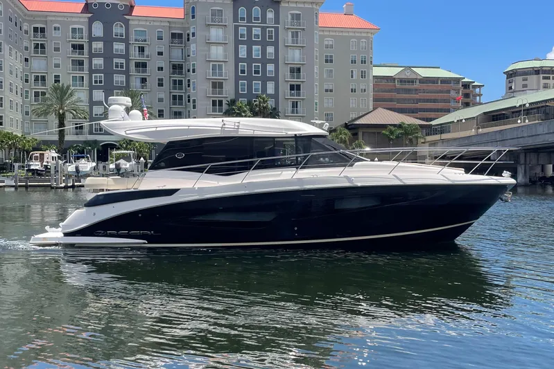 Caribbean Smile Yacht Photos Pics 2019 Regal 42 Grande Coupe yacht docked in a marina with waterfront buildings.