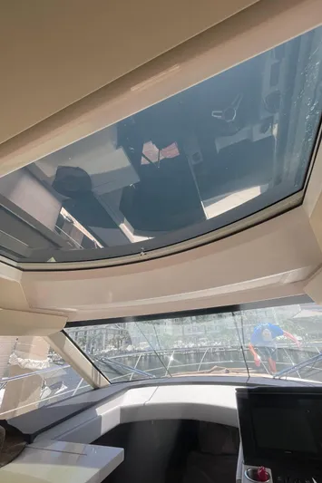 Caribbean Smile Yacht Photos Pics Interior view of 2019 Regal 42 Grande Coupe yacht with sunroof and navigation system.