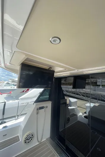 Caribbean Smile Yacht Photos Pics 2019 Regal 42 Grande Coupe yacht interior with TV and seating area.