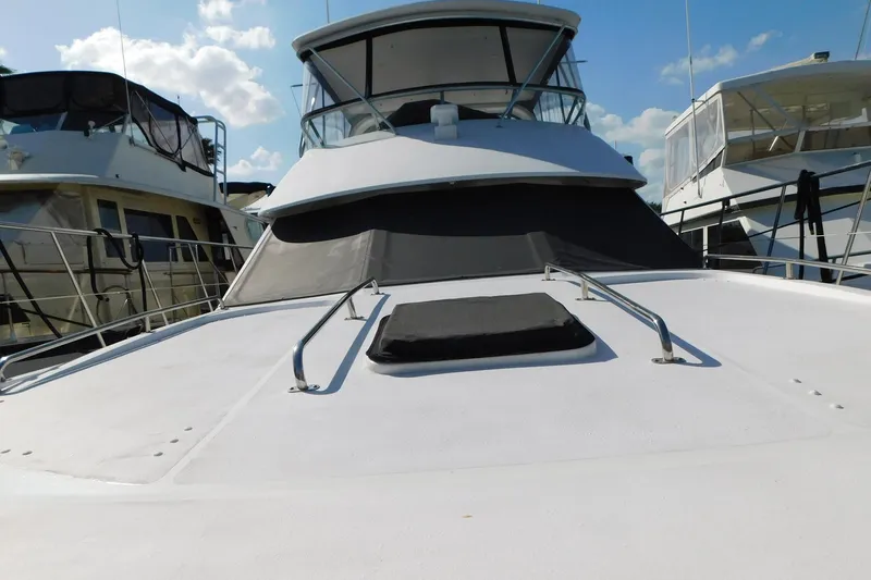 Driftwood Yacht Photos Pics 1995 Jefferson 52 Riviana Cockpit MY yacht docked under a clear blue sky.