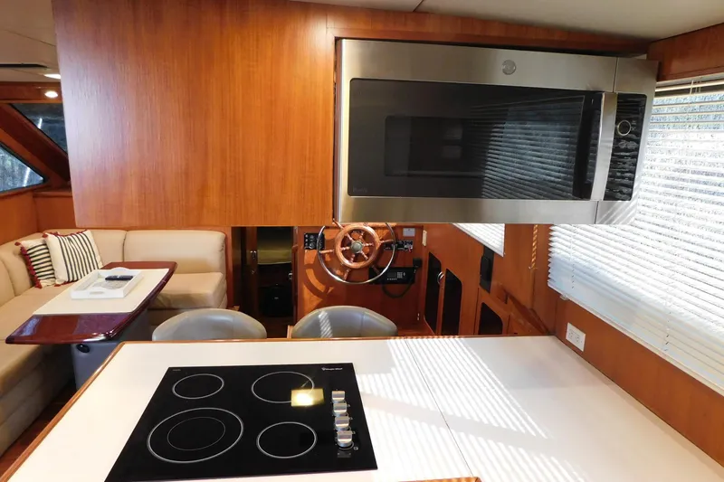 Driftwood Yacht Photos Pics Interior of 1995 Jefferson 52 Riviana Cockpit MY yacht with modern kitchen and seating area.