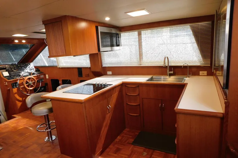 Driftwood Yacht Photos Pics Interior of 1995 Jefferson 52 Riviana Cockpit MY yacht with modern kitchen and helm.