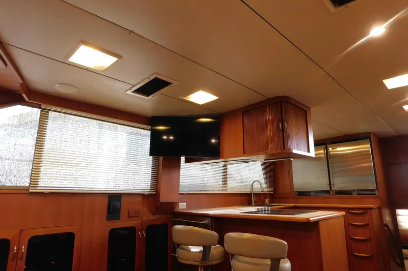 Driftwood Yacht Photos Pics Interior of 1995 Jefferson 52 Riviana Cockpit MY yacht with modern kitchen and seating area.