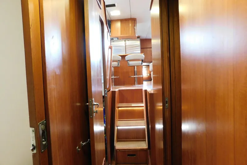 Driftwood Yacht Photos Pics Interior view of 1995 Jefferson 52 Riviana Cockpit MY yacht with wooden paneling and stairs.