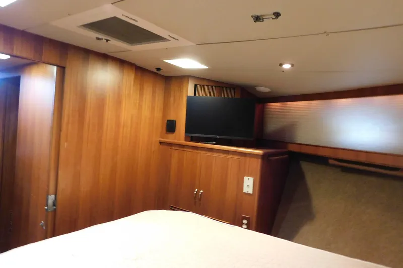 Driftwood Yacht Photos Pics Interior of 1995 Jefferson 52 Riviana Cockpit MY with wood paneling and mounted TV.