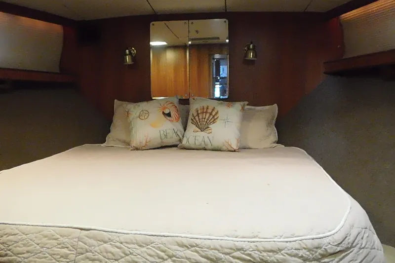 Driftwood Yacht Photos Pics Cozy bedroom in 1995 Jefferson 52 Riviana Cockpit MY yacht with nautical-themed pillows.