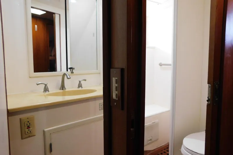 Driftwood Yacht Photos Pics Bathroom interior of 1995 Jefferson 52 Riviana Cockpit MY yacht, featuring sink and shower.