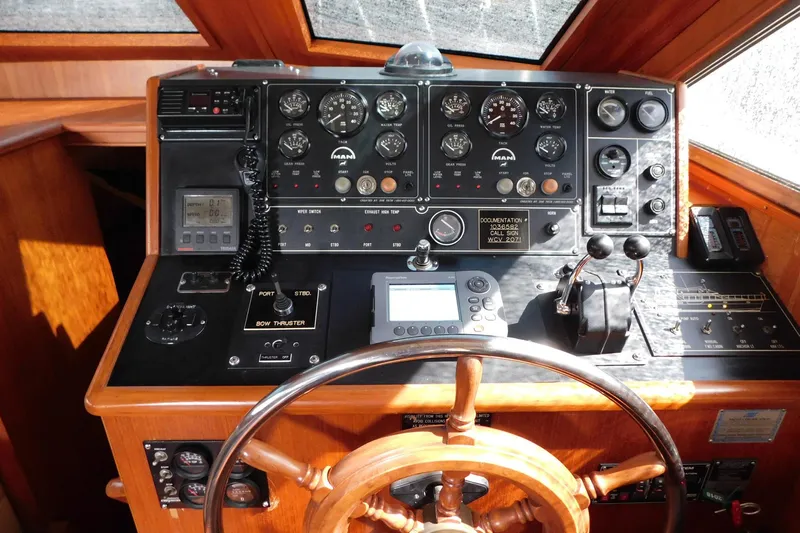 Driftwood Yacht Photos Pics 1995 Jefferson 52 Riviana Cockpit MY helm with gauges, controls, and wooden steering wheel.