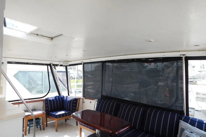 Driftwood Yacht Photos Pics Interior of 1995 Jefferson 52 Riviana Cockpit MY with seating and table.