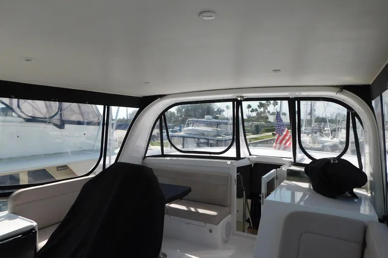 Driftwood Yacht Photos Pics Interior view of 1995 Jefferson 52 Riviana Cockpit MY yacht with American flag visible.