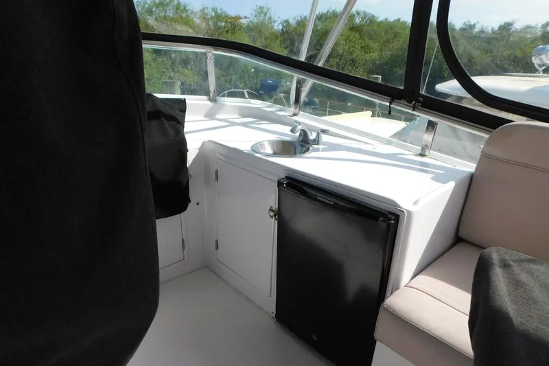 Driftwood Yacht Photos Pics 1995 Jefferson 52 Riviana Cockpit MY interior with sink and mini fridge.