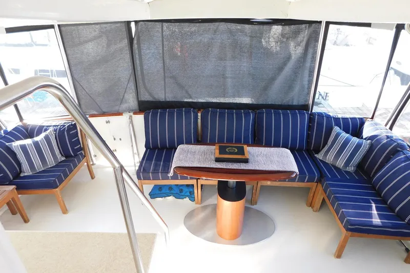 Driftwood Yacht Photos Pics 1995 Jefferson 52 Riviana Cockpit MY interior with blue striped seating and table.