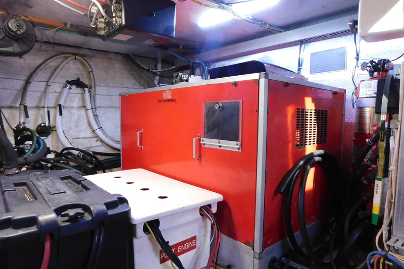 Driftwood Yacht Photos Pics Engine room of 1995 Jefferson 52 Riviana Cockpit MY with red machinery and cables.