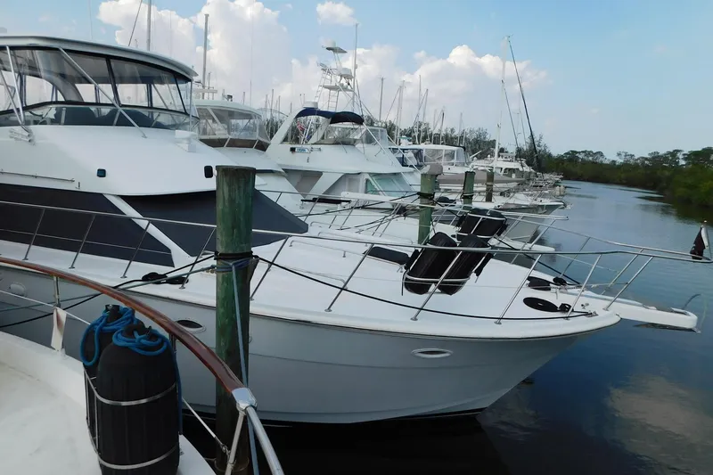 Driftwood Yacht Photos Pics 1995 Jefferson 52 Riviana Cockpit MY yacht docked in a marina, surrounded by other boats.