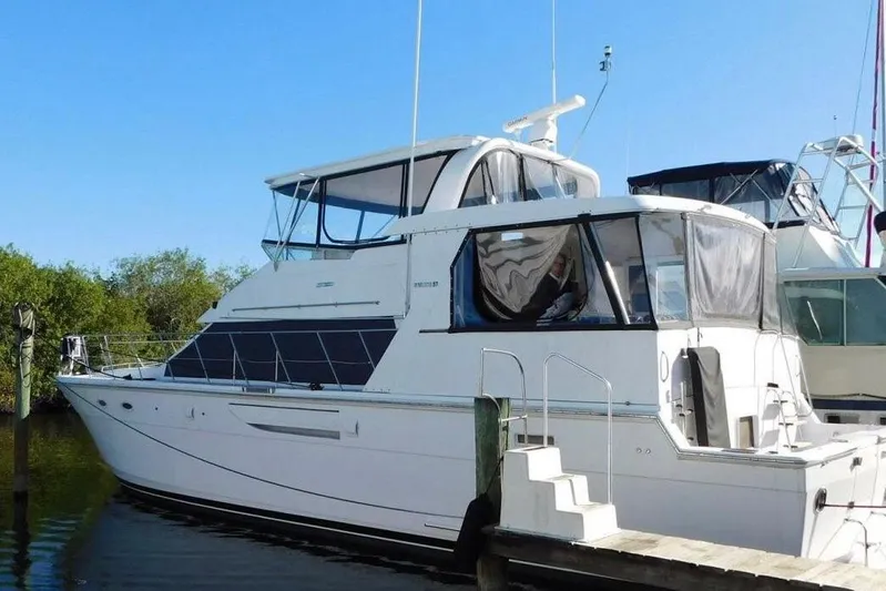 Driftwood Yacht Photos Pics 1995 Jefferson 52 Riviana Cockpit MY yacht docked, featuring sleek design and spacious cockpit.