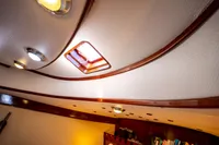 Interior of 2016 Custom Trawler with wooden trim and ceiling lights.