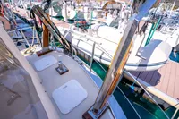 Custom 2016 Trawler docked at marina, showcasing deck and nearby boats.