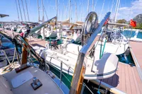 Docked custom trawler boats at marina, 2016 model, under clear blue sky.