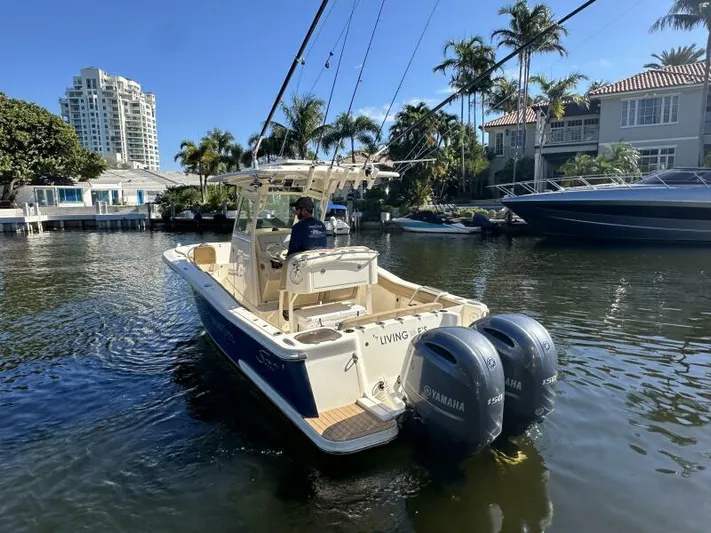 T/t Living With E's Yacht Photos Pics 2018 Scout 255LXF boat with dual Yamaha engines on a sunny canal.