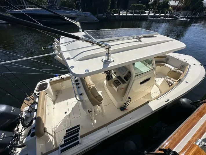 T/t Living With E's Yacht Photos Pics 2018 Scout 255LXF boat docked, featuring spacious deck and modern design.