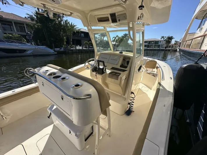 T/t Living With E's Yacht Photos Pics 2018 Scout 255LXF boat interior with helm, seating, and waterway view.