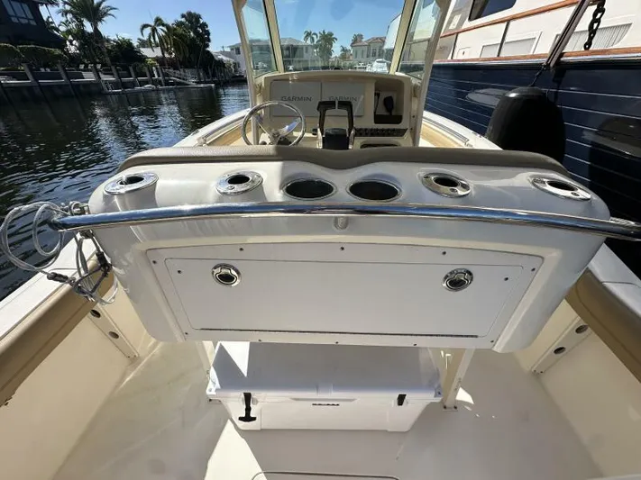 T/t Living With E's Yacht Photos Pics 2018 Scout 255LXF boat interior with fishing rod holders and console.