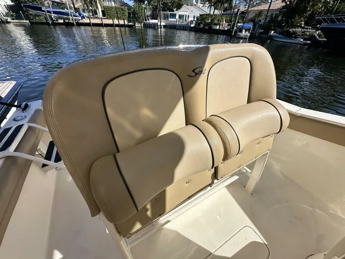 T/t Living With E's Yacht Photos Pics 2018 Scout 255LXF boat seating with tan upholstery by the water.