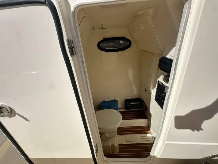 T/t Living With E's Yacht Photos Pics 2018 Scout 255LXF boat interior with toilet and storage compartments.