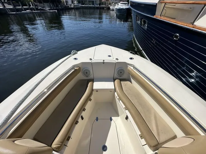 T/t Living With E's Yacht Photos Pics 2018 Scout 255LXF boat interior with tan seating, docked in marina.
